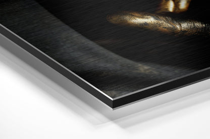 Close-up angled view of layered Dibond wall art showing brushed black aluminum surface with white backing board and gold-toned decorative element.