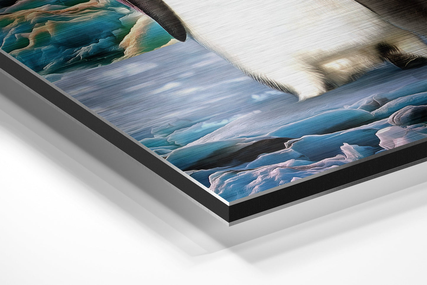 Angled detail shot of brushed aluminium Dibond wall art showing layered frame construction with coastal landscape scene featuring blue water and white penguins.