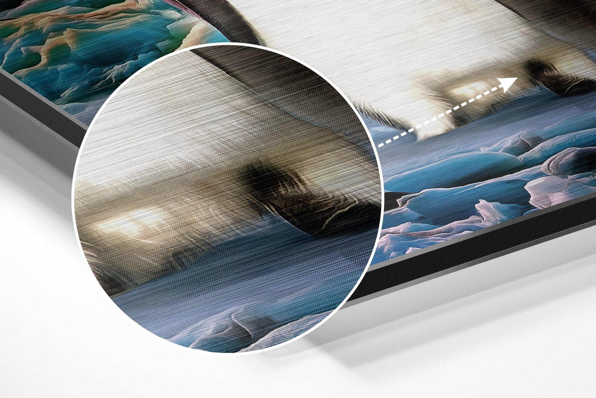 Close-up detail of brushed aluminium surface showing penguin artwork with blue water and white ice textures visible through magnified circular lens.
