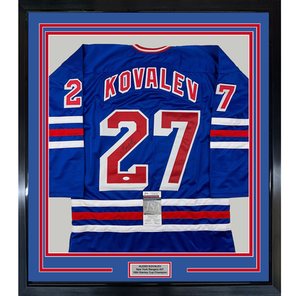 Framed blue New York Rangers jersey #27 signed by Kovalev, displayed front-facing with red and white stripes and JSA authentication certificate visible.