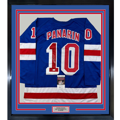 Blue New York Rangers jersey number 10 with "PANARIN" nameplate, framed with red and white striped sleeves, JSA authentication certificate visible.