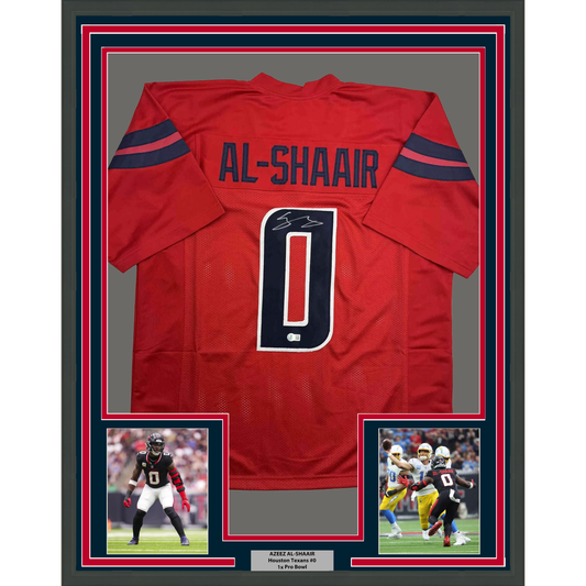 Red Houston Texans football jersey number 0 with "AL-SHAAIR" nameplate, signed, displayed in frame with two action photos below.