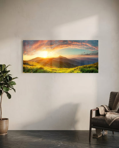 Valley Glass Wall Art mounted on white wall showing golden sunset over green mountain landscape with dramatic sky.