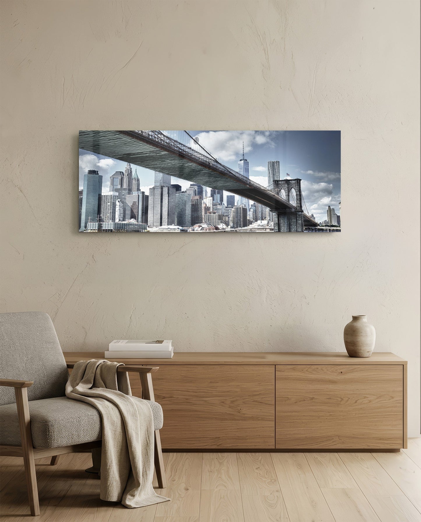 Brooklyn Bridge glass wall art displaying Manhattan skyline and bridge spanning across beige interior wall above wooden dresser.