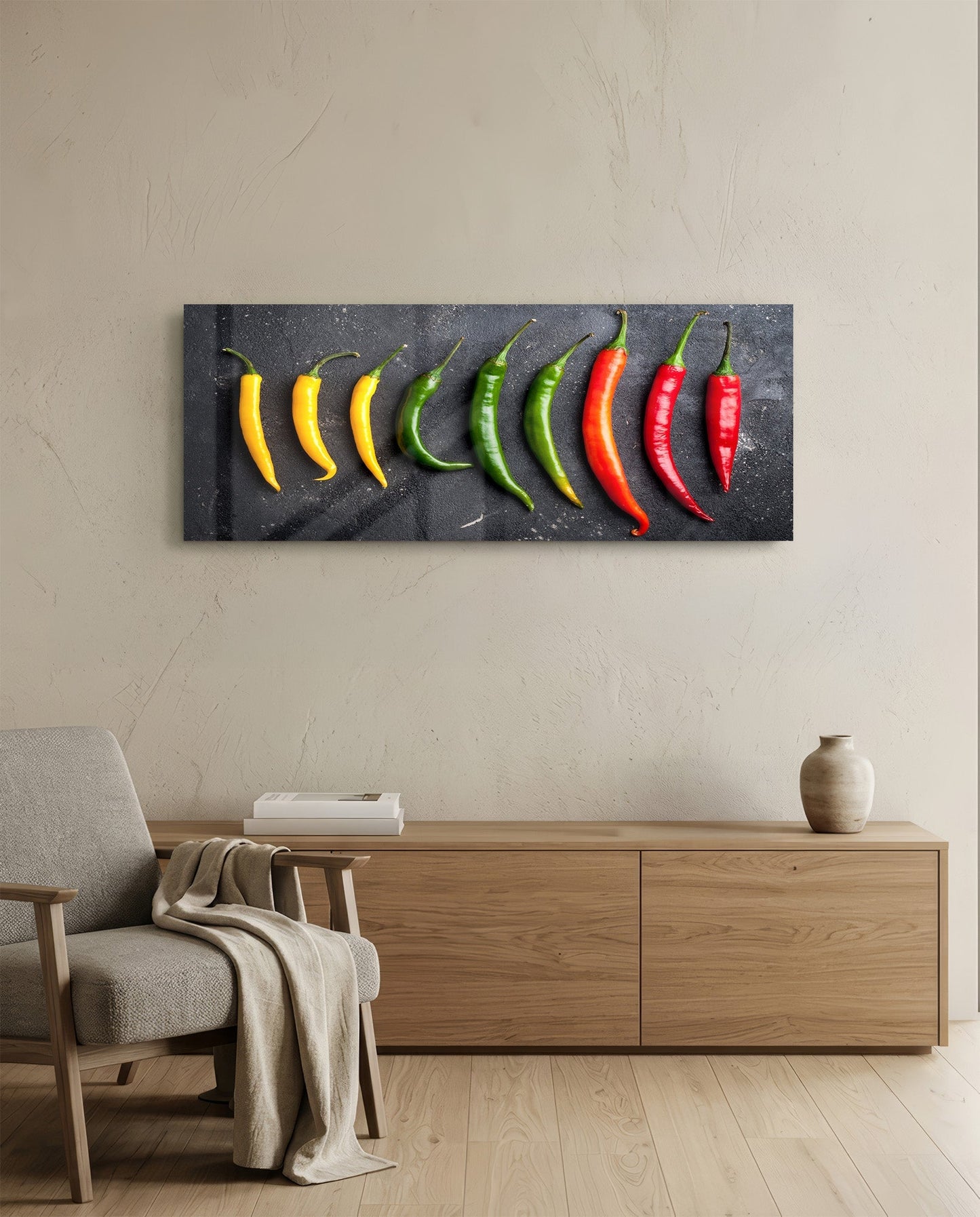 Pepper Glass Wall Art mounted above wooden dresser in modern living room, displaying nine chili peppers in yellow, green, and red gradient on dark background.