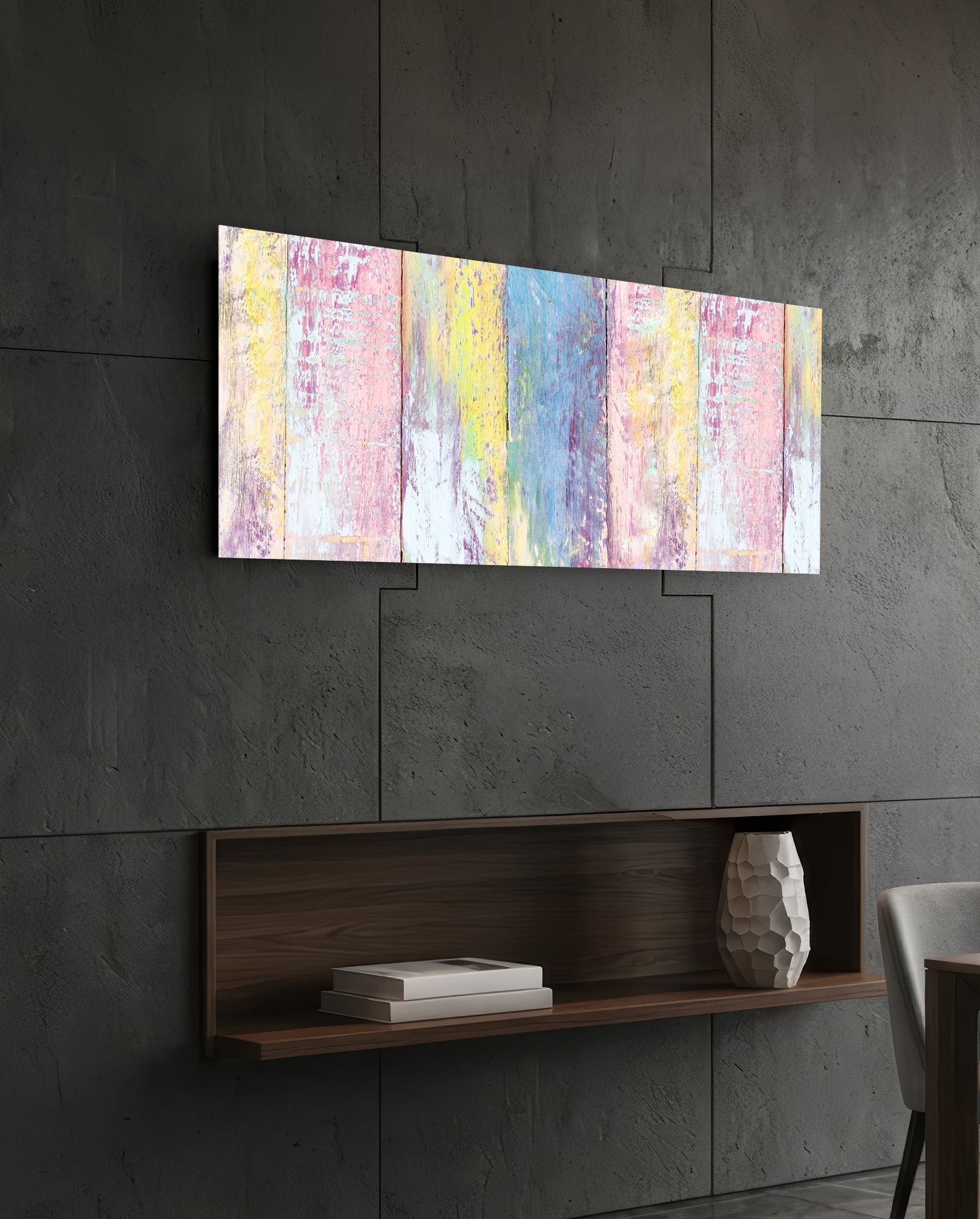 Horizontal painted wood glass wall art displaying vertical stripes in pastel pink, yellow, and blue hung above a dark wooden shelf.