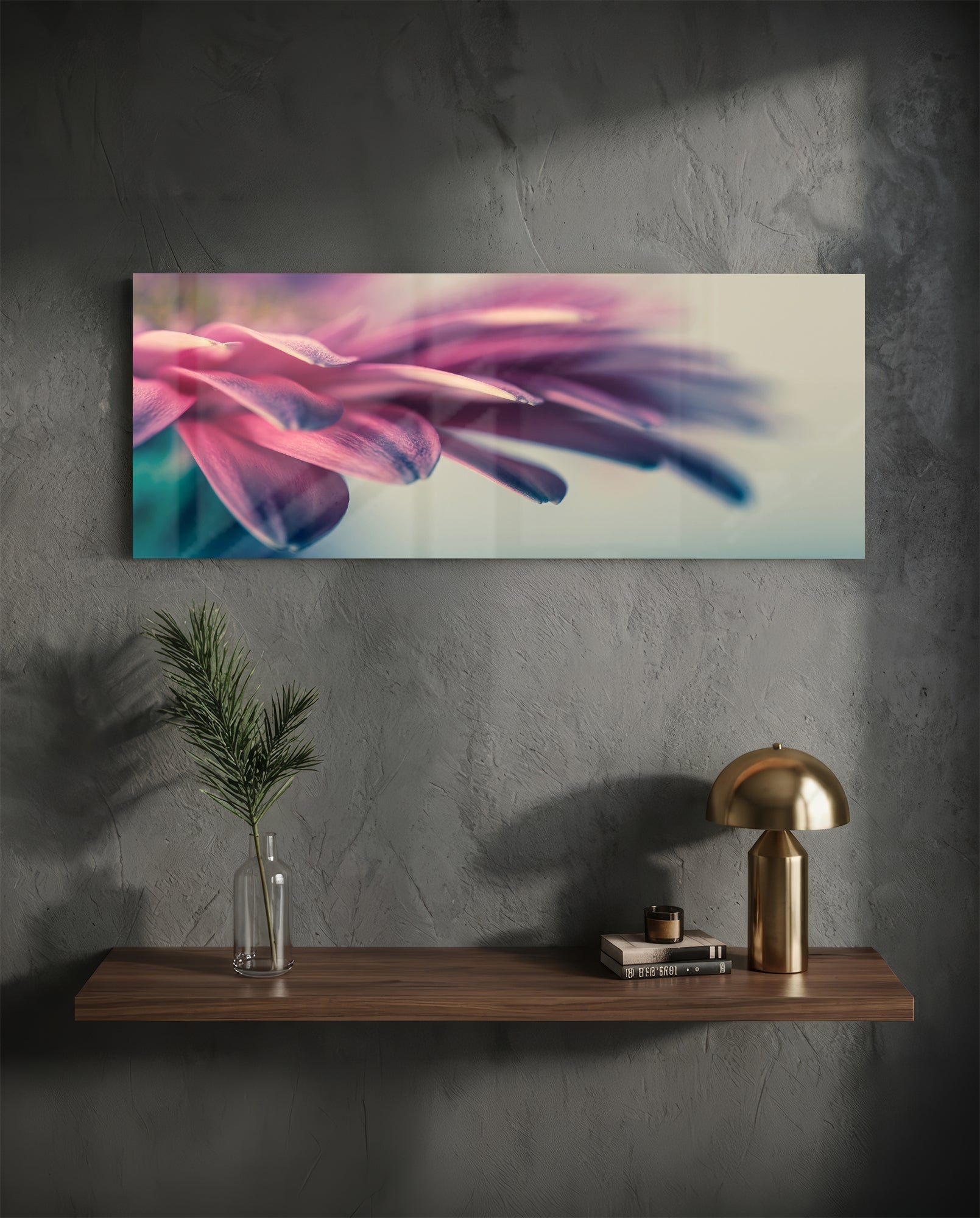 Macro glass wall art displaying close-up pink and purple flower petals with soft focus, mounted above wooden shelf with brass lamp and plant.