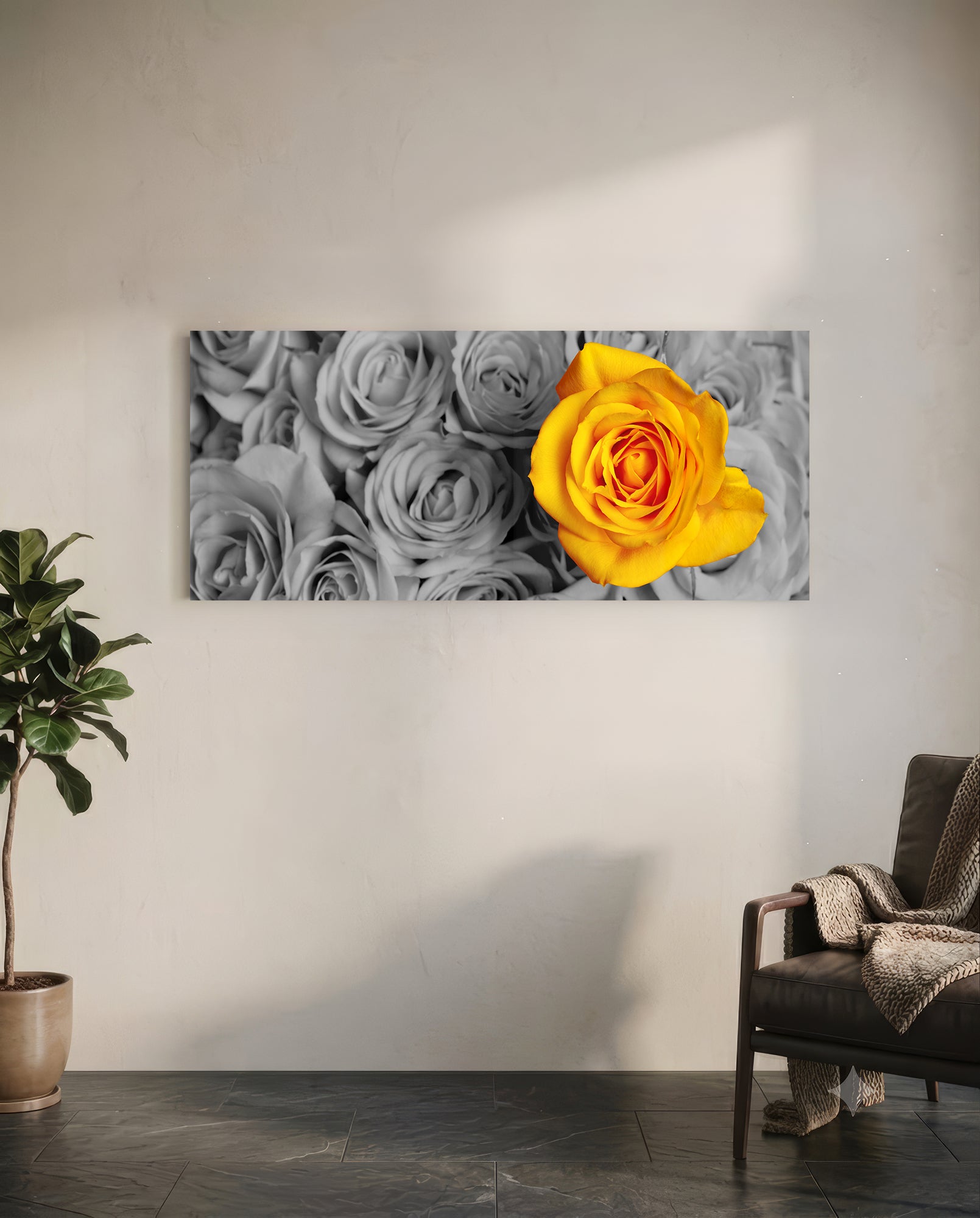 Yellow rose glass wall art hanging above a potted plant and leather chair in a minimalist room with gray roses in background.
