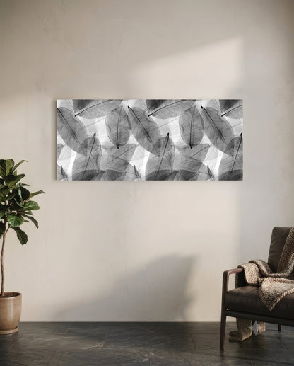 Black and white translucent leaf pattern glass wall art hanging above a leather chair in a minimalist room setting.