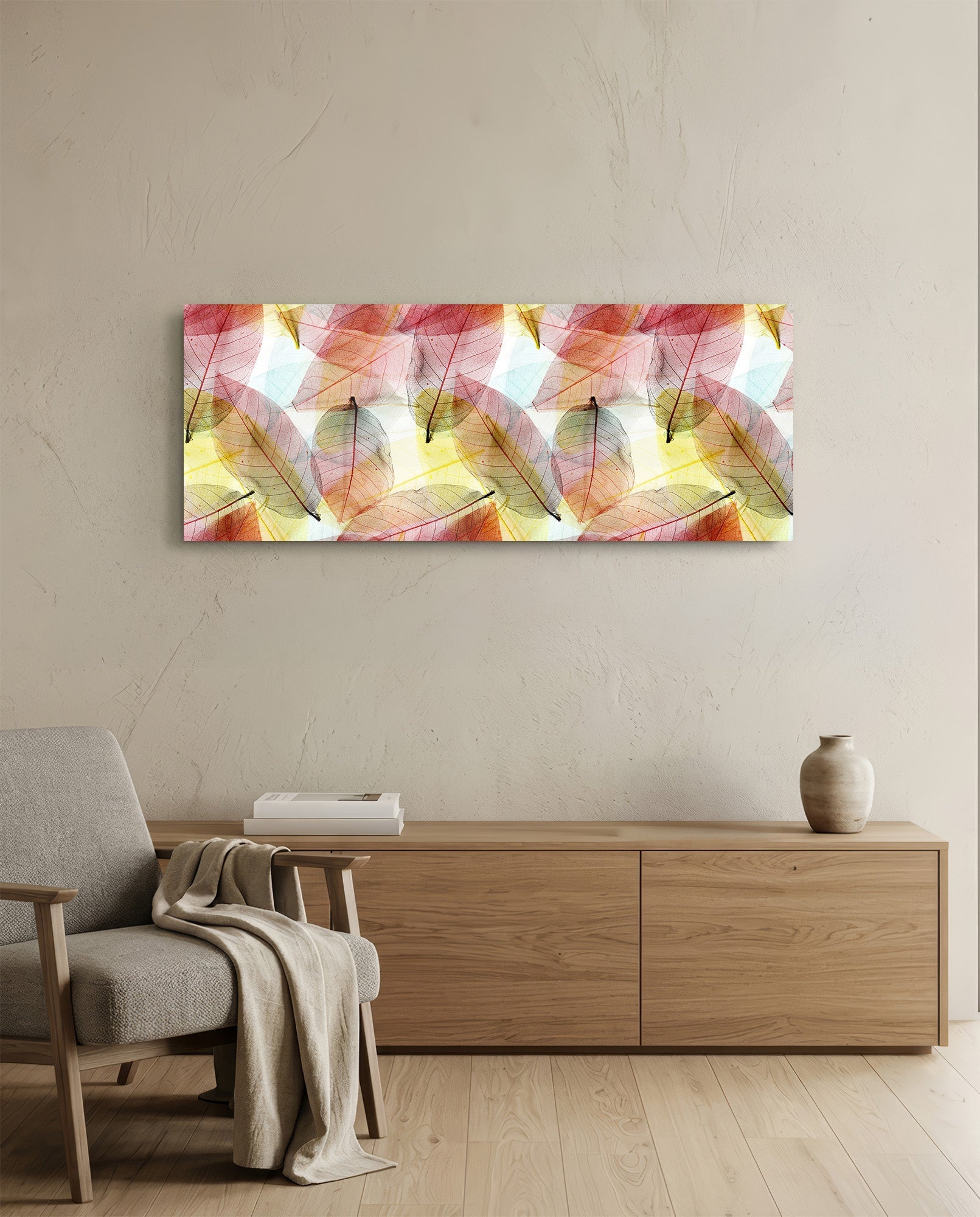 Horizontal glass wall art featuring translucent red, pink, and yellow leaves on white background, hung above wooden dresser in minimalist room.
