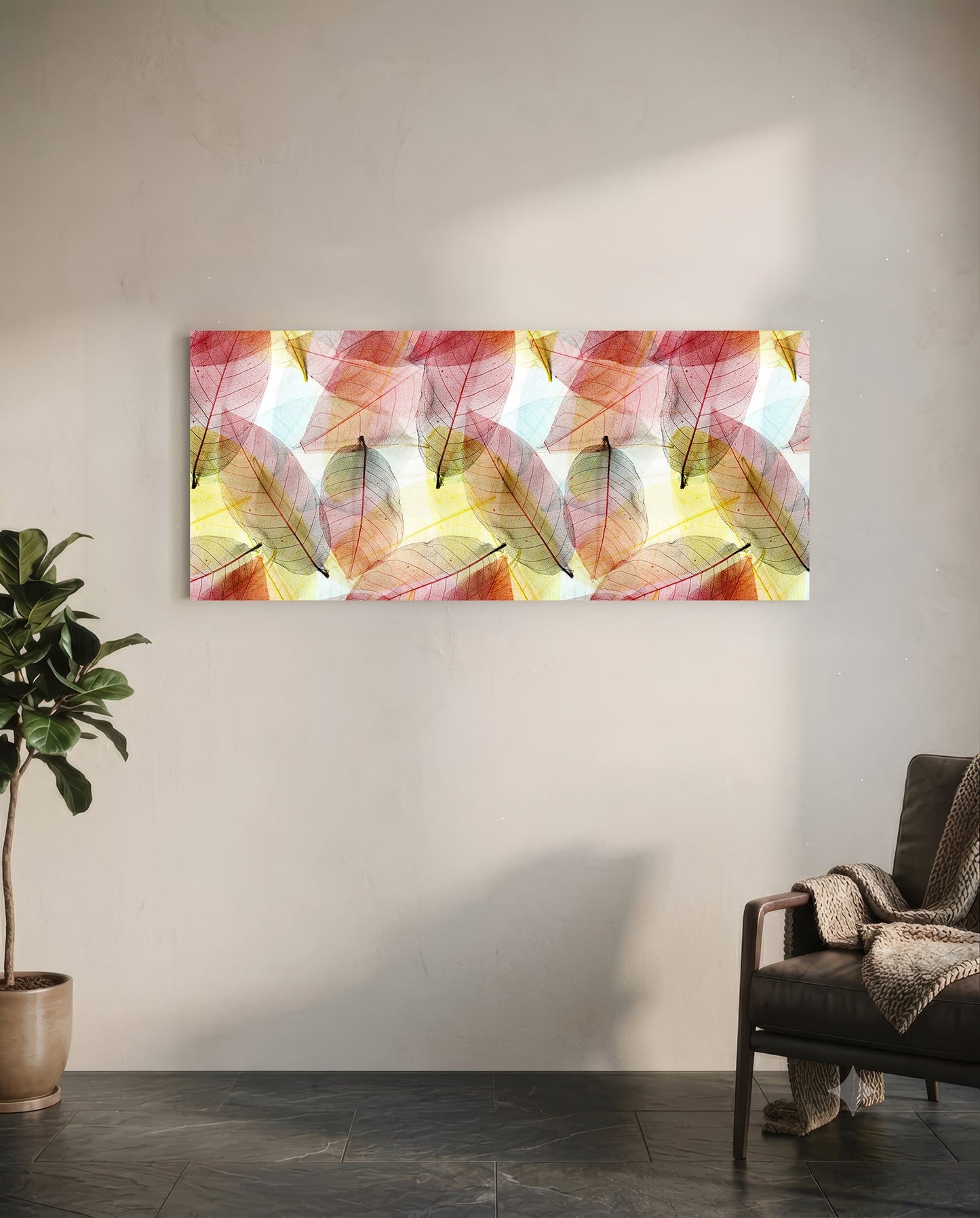 Translucent colored leaf glass art panel mounted on white wall above chair, displaying pink, red, yellow, and green autumn leaves.