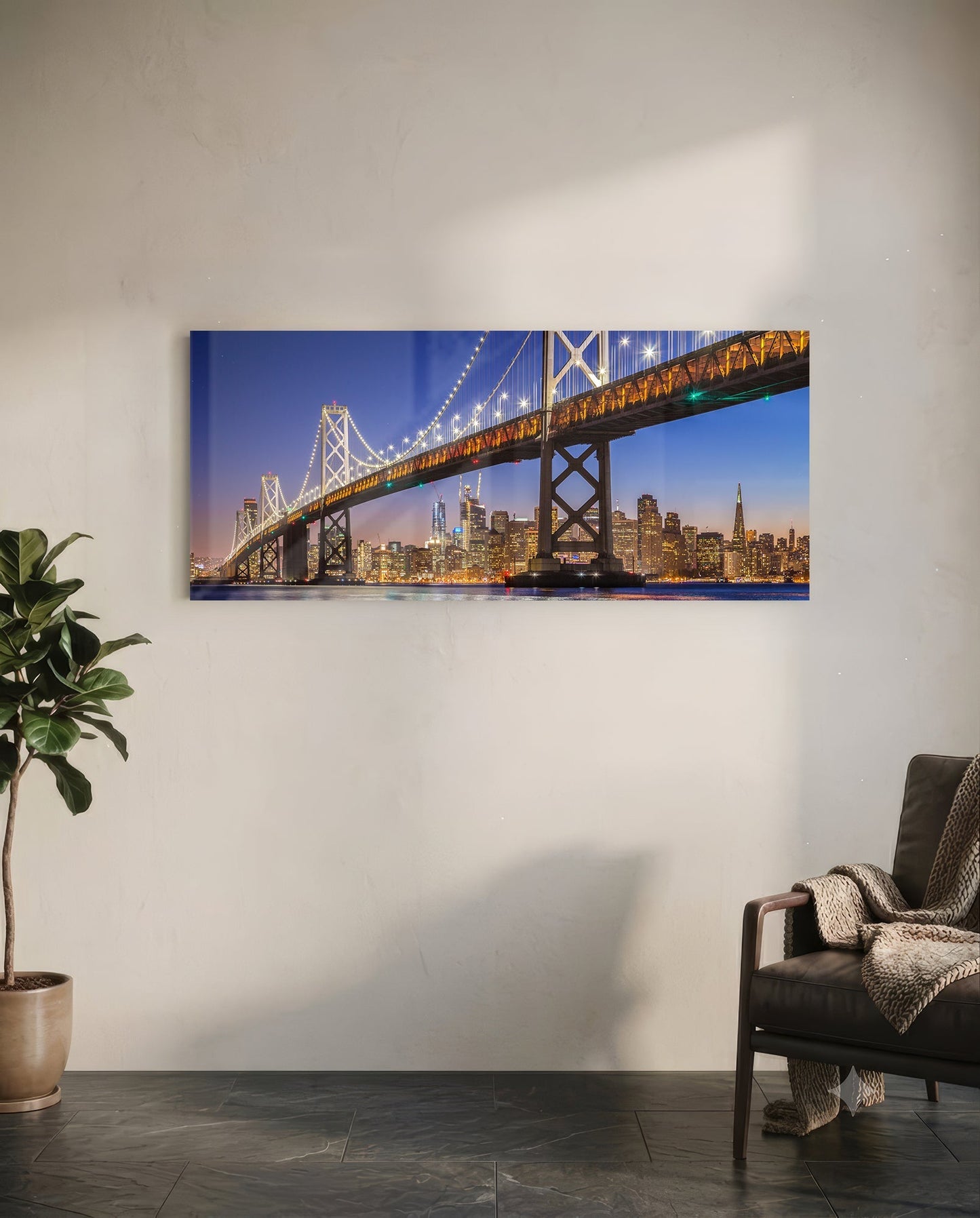 Illuminated Bay Bridge and San Francisco skyline at twilight displayed as horizontal glass wall art in modern living room setting.