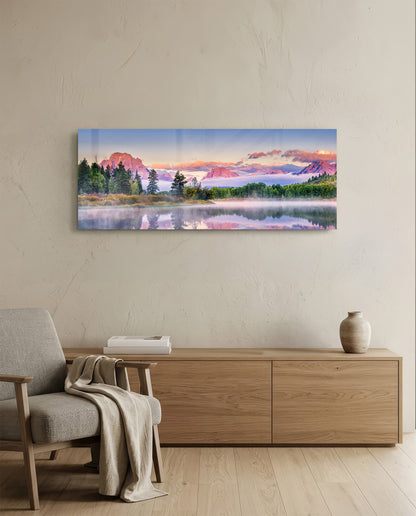 Panoramic glass art hung above wooden dresser showing misty lake with pink-toned mountains and evergreen trees at sunrise.