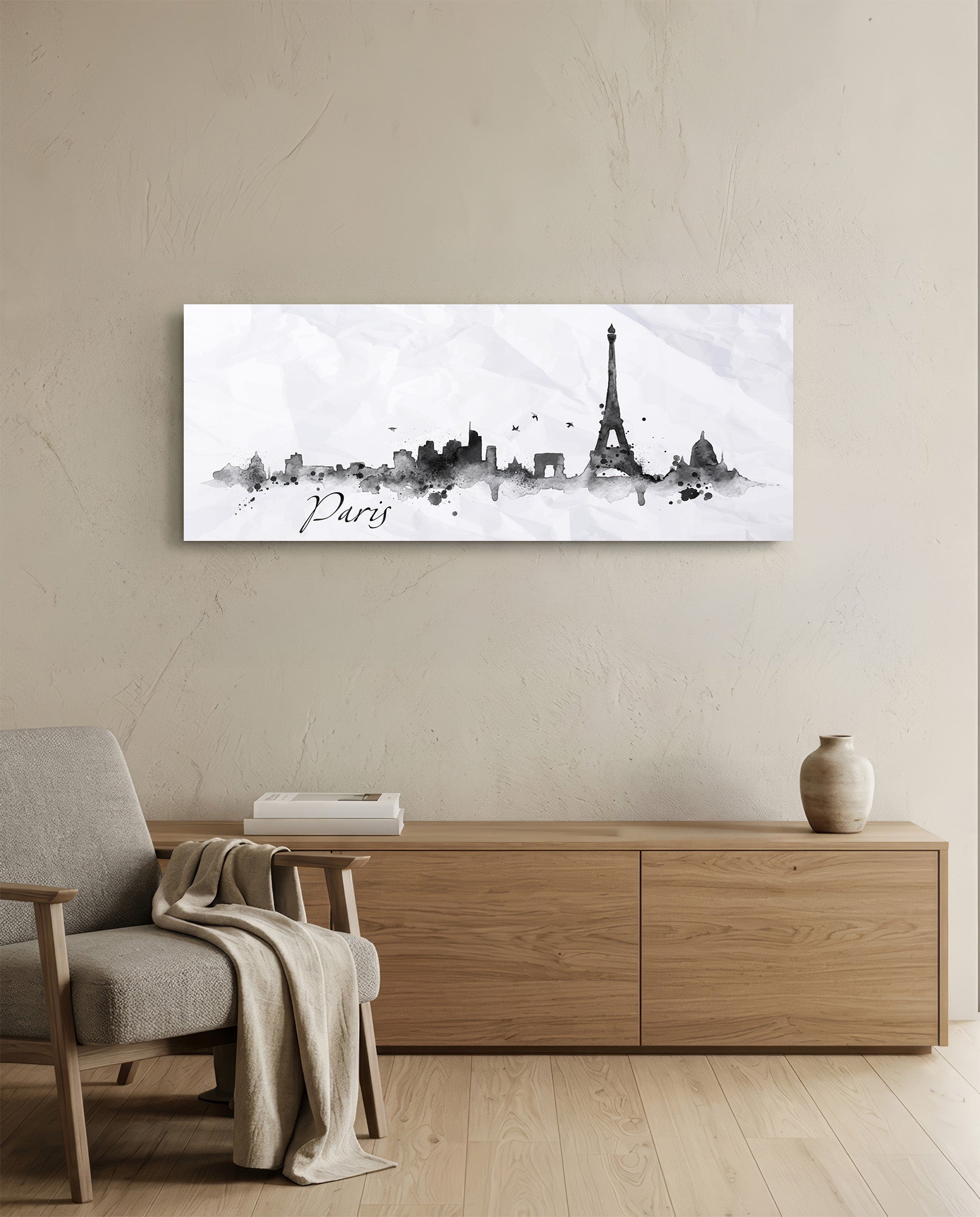 Paris skyline watercolor art in black and gray tones hanging above wooden dresser in modern living room setting.