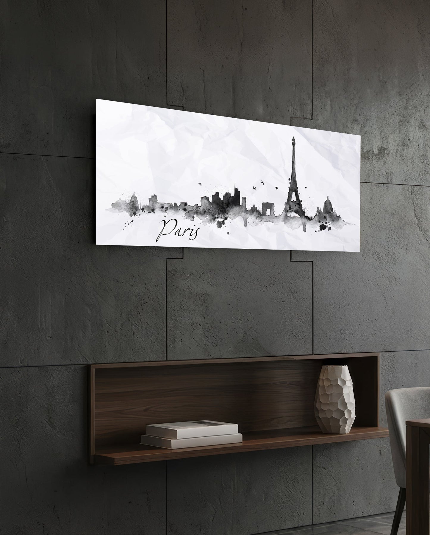 Paris skyline watercolor art in black and gray on white glass panel mounted above wooden shelf on concrete wall.