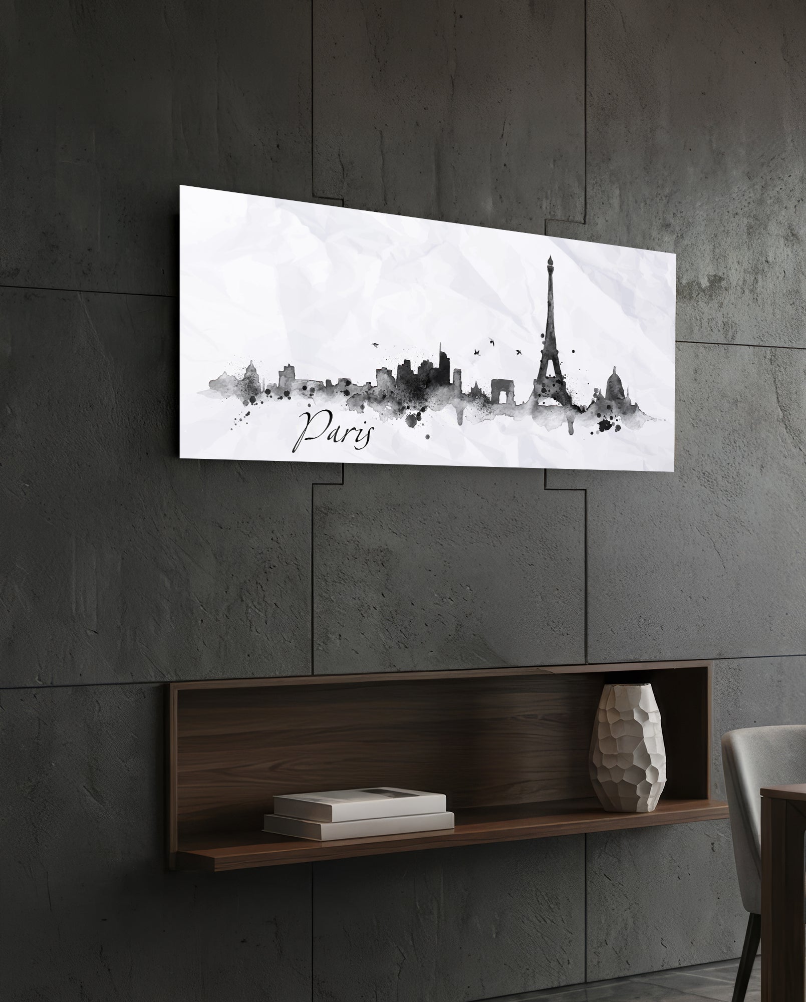 Paris skyline watercolor art in black and gray on white glass panel mounted above wooden shelf on concrete wall.