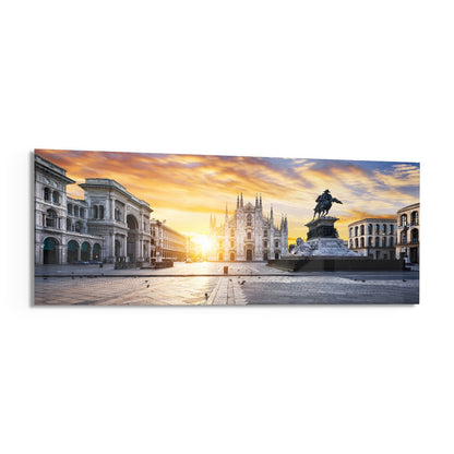 Panoramic glass wall art depicting Milan's Piazza Duomo at golden sunrise with cathedral, equestrian statue, and Renaissance architecture.