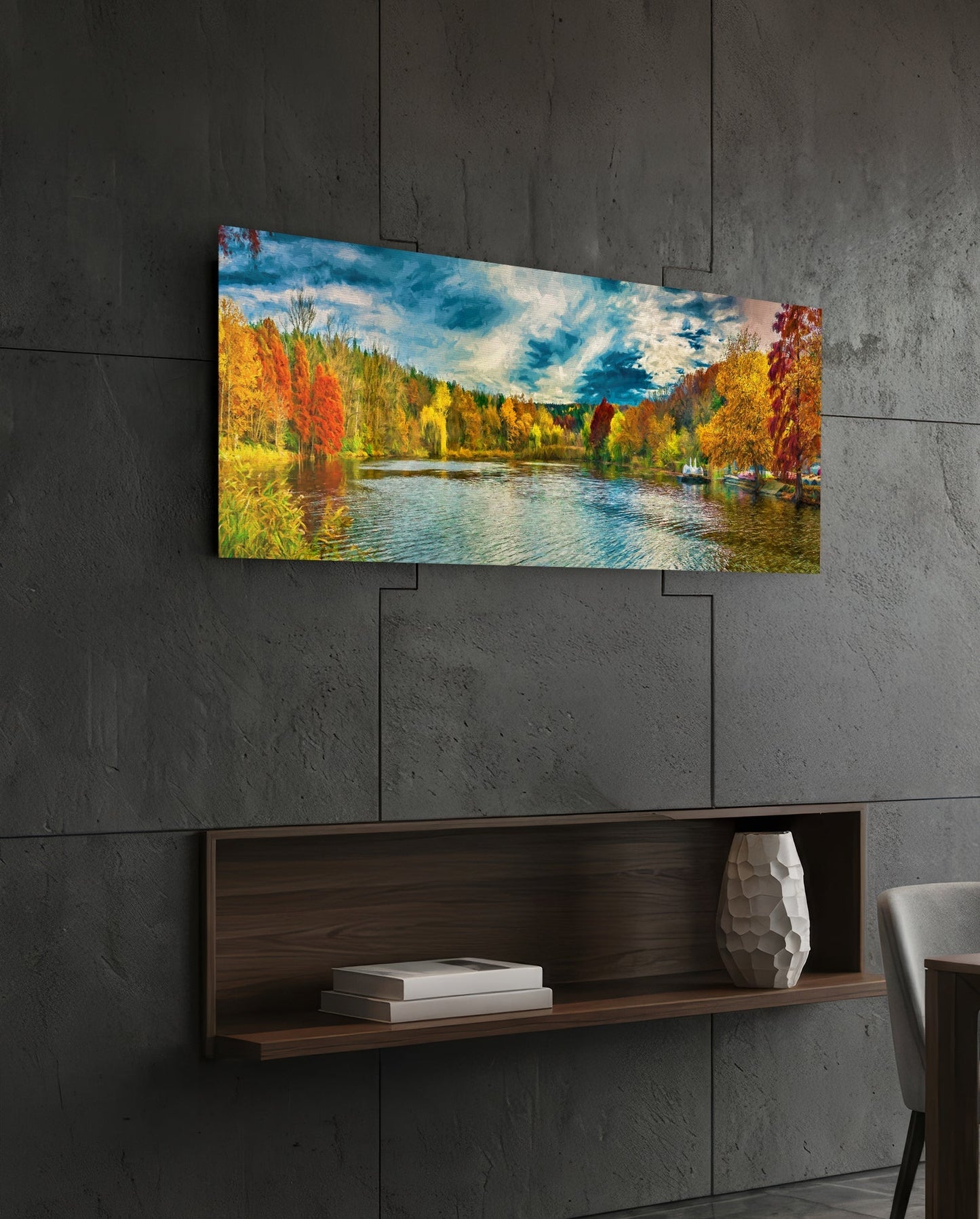 Horizontal glass wall art displaying autumn lakeside landscape with colorful fall trees, blue water, and sky, mounted on concrete wall above wooden shelf.