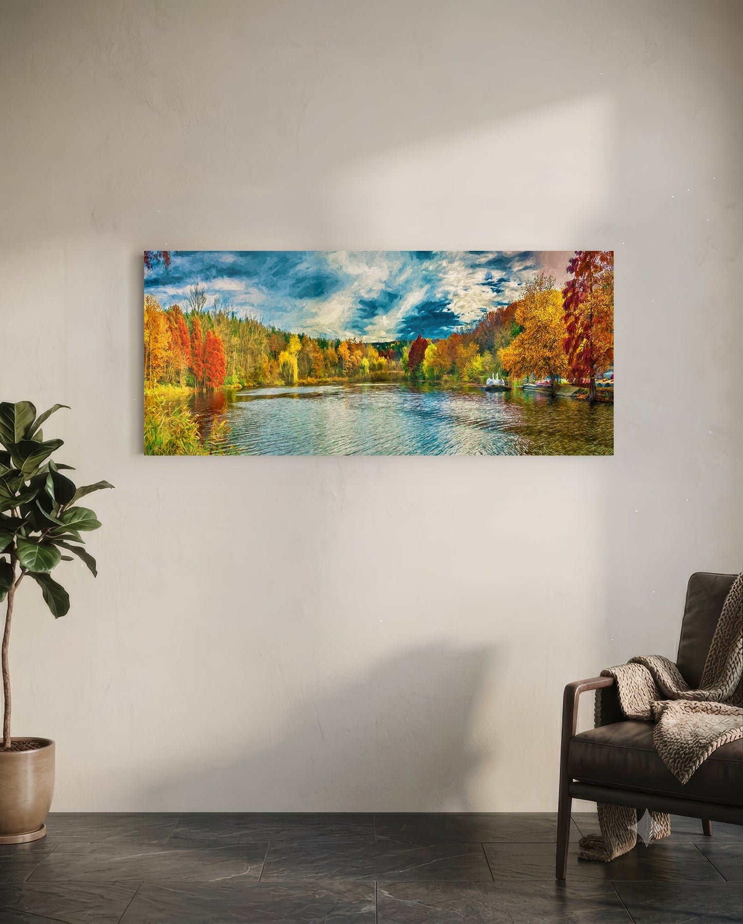 Horizontal glass wall art depicting an autumn river landscape with colorful fall foliage, blue water, and cloudy sky, displayed above a chair in a minimalist interior.