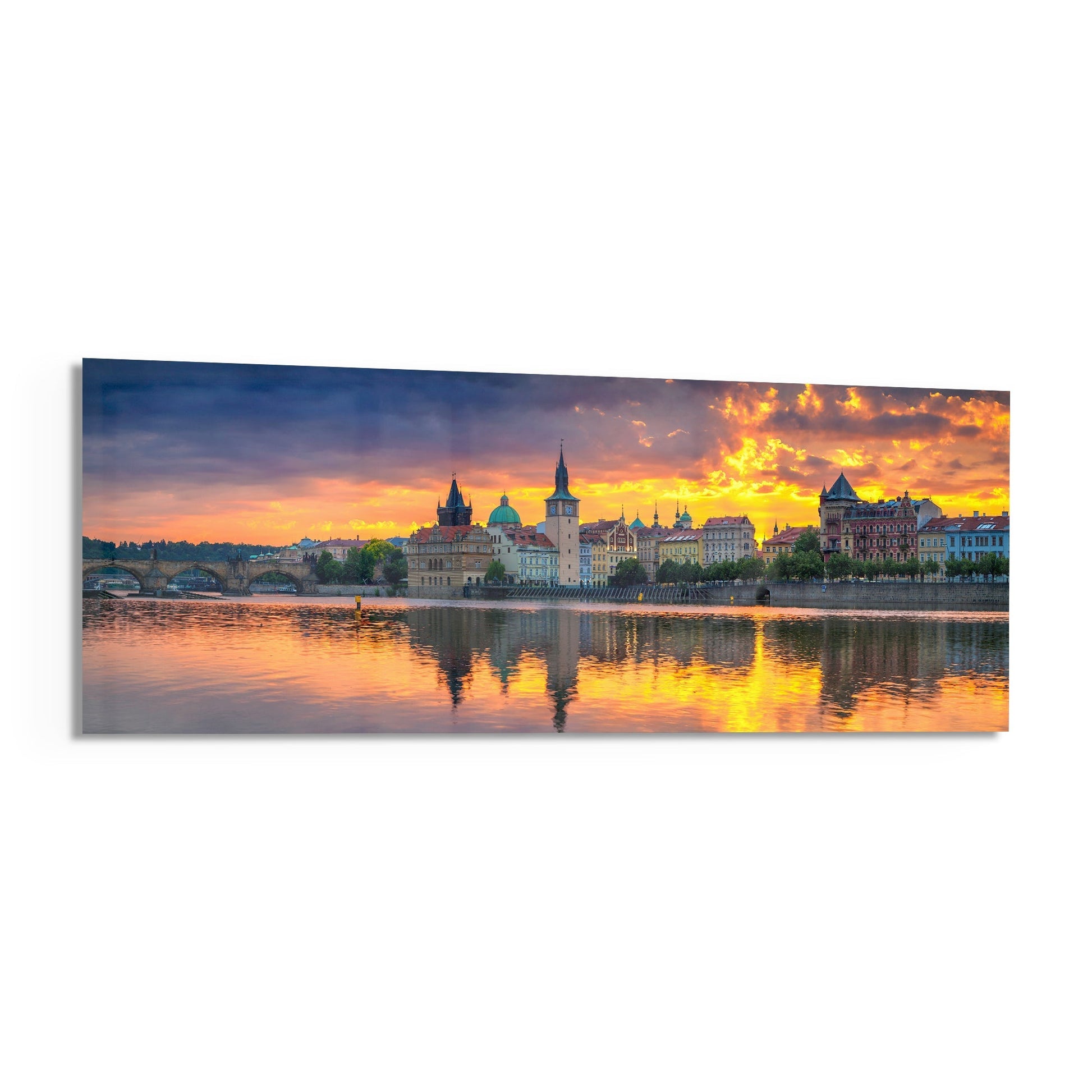 Prague skyline at golden sunset reflected in the Vltava River, featuring historic architecture and bridges under dramatic orange sky on panoramic glass panel.