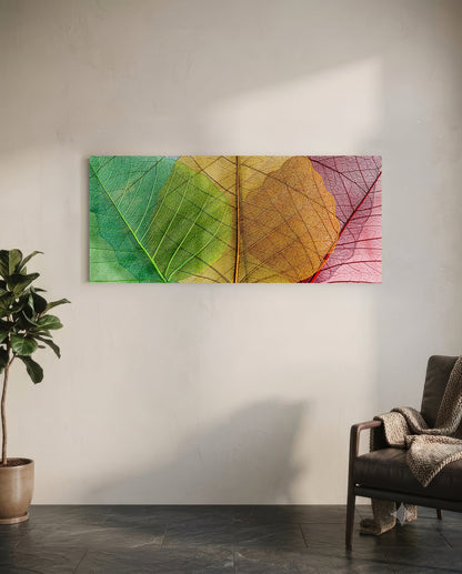 Colorful glass wall art featuring translucent leaves in gradient rainbow hues displayed in modern living room interior.