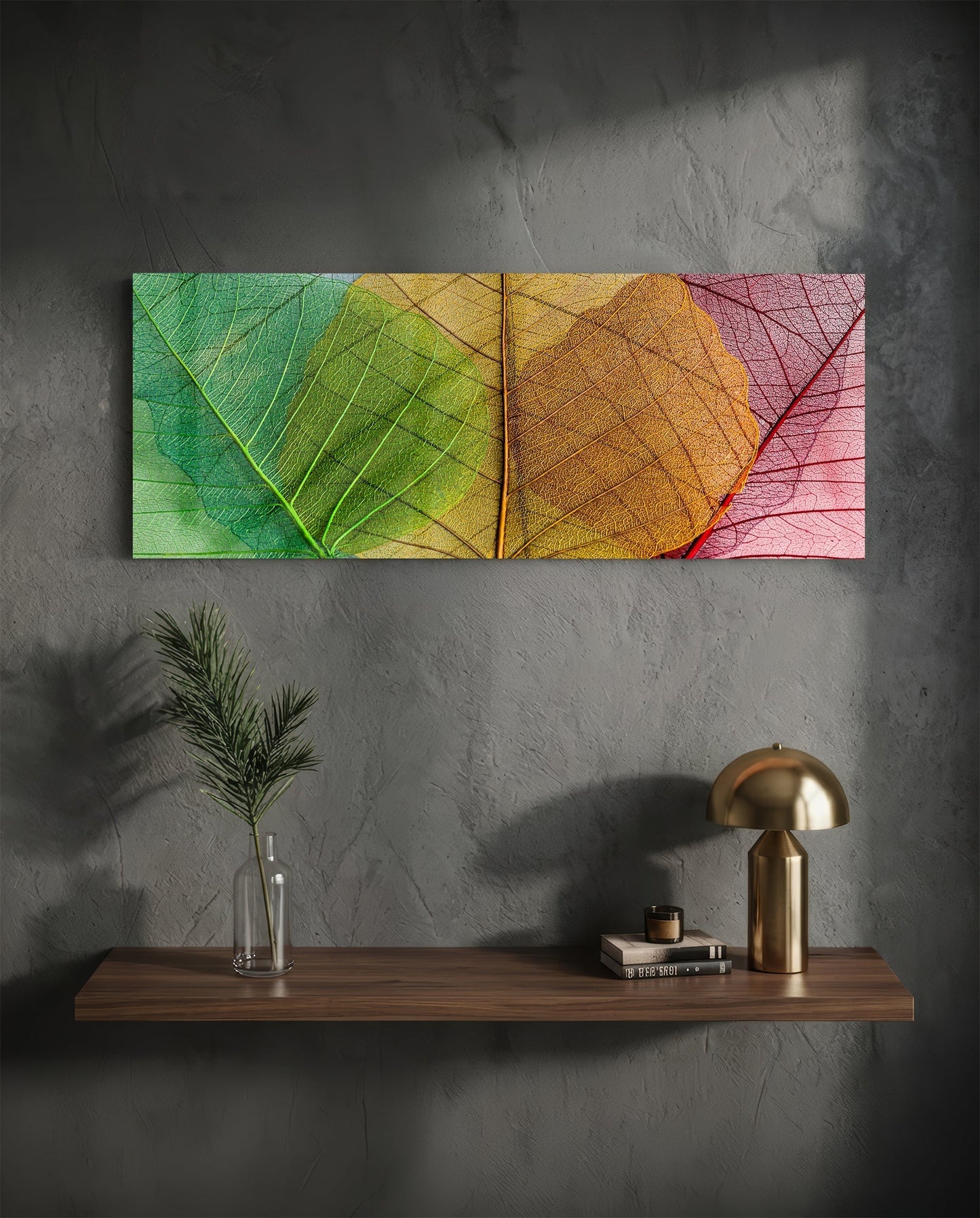 Colorful glass leaf wall art with green, yellow, orange, and pink gradient displayed above wooden shelf with brass lamp and plant vase.