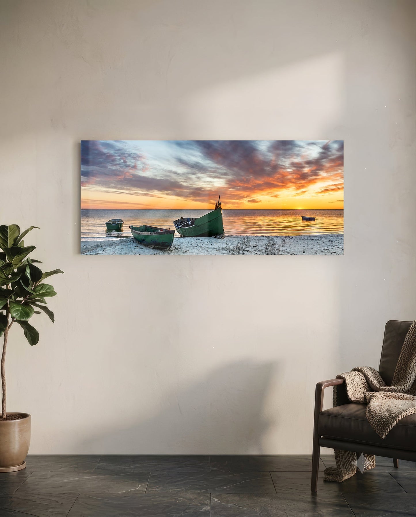 Glass wall art depicting three green fishing boats on a beach at sunset with orange and blue sky, displayed in a modern living room.