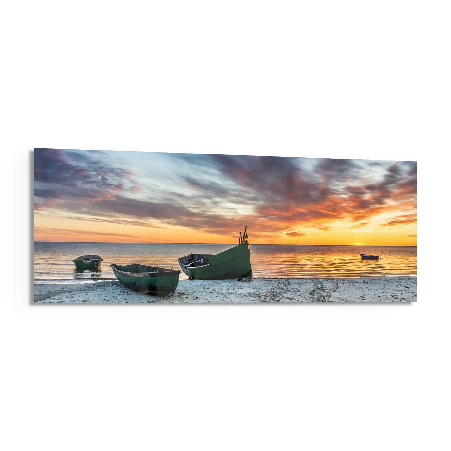 Green fishing boats beached on sand at sunset with golden sky and calm ocean water.