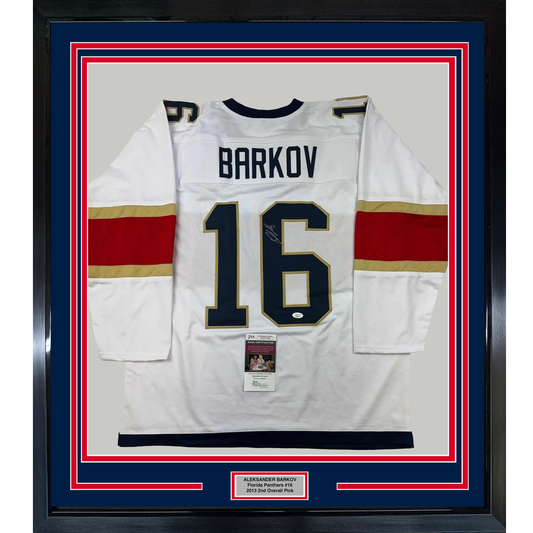 White Florida Panthers hockey jersey number 16 with "BARKOV" nameplate, signed, displayed in blue and red frame with JSA certification label.