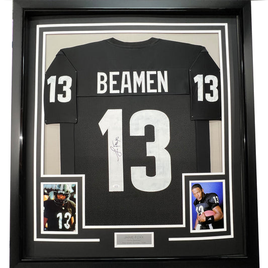Black framed football jersey displaying "BEAMEN 13" with autograph, flanked by two player photographs and nameplate plaque.