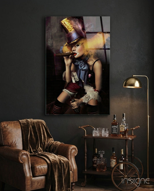 Multi-panel glass wall art depicting stylized woman in gold top hat and black outfit smoking cigar, displayed above leather armchair in dark interior setting.