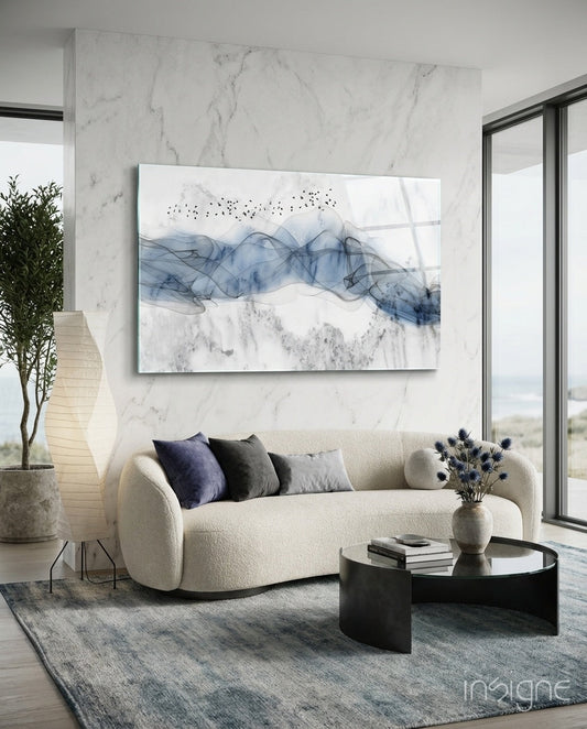 Blue Fog Glass Wall Art displayed above cream curved sofa in modern marble living room with black coffee table.