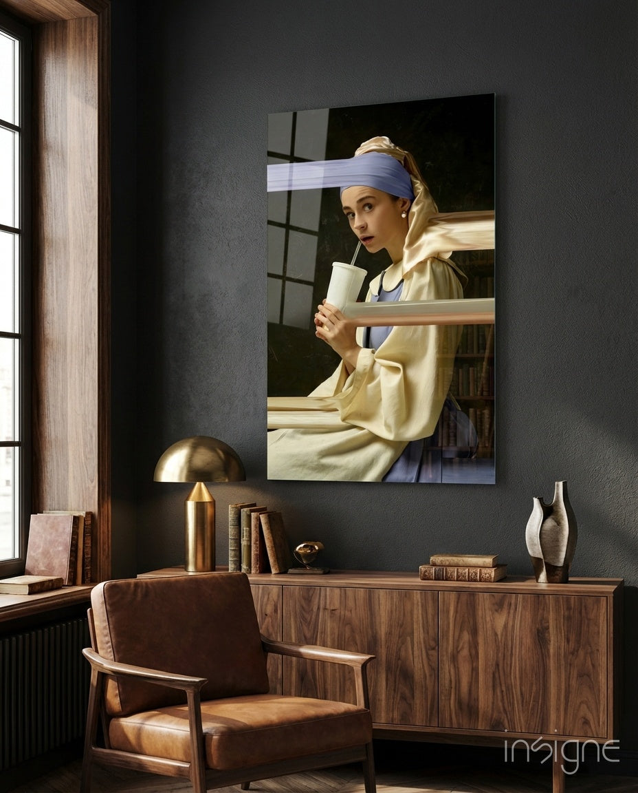 Girl with a Pearl Earring glass wall art displayed above wooden dresser in modern study room with leather chair and brass lamp.