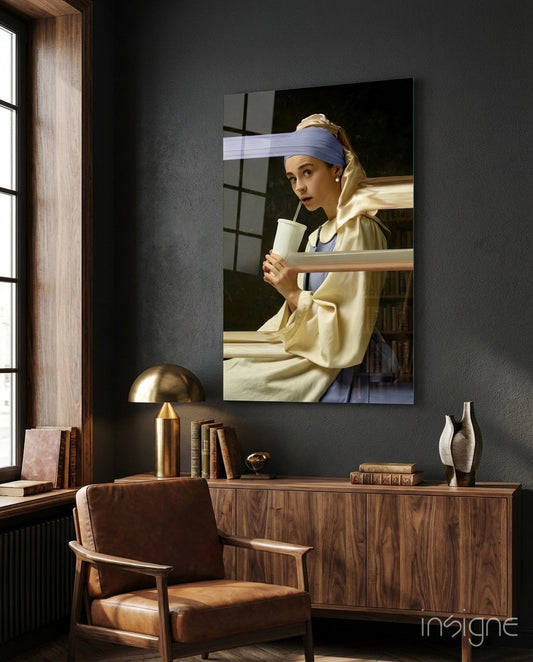 Girl with a Pearl Earring glass wall art displayed above wooden dresser in modern study room with leather chair and brass lamp.