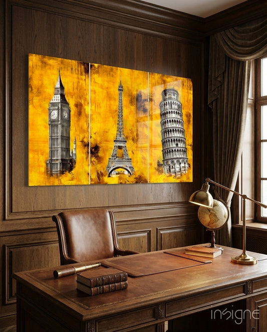 Three-panel yellow glass artwork displaying Big Ben, Eiffel Tower, and Leaning Tower of Pisa mounted above wooden desk in study room.