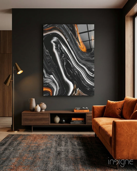 Black Agate Orange Swirl Glass Wall Art displayed on dark wall above wooden console in modern living room with orange leather sofa.