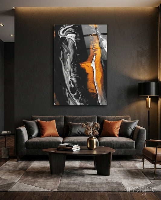 Orange, black, and white marbled glass wall art displayed above a dark gray sofa in a modern living room.