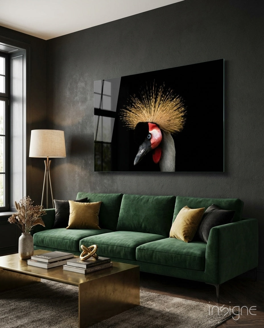 Crane Bird Glass Wall Art displaying a red-headed crane with golden crest on black background, mounted above green sofa in modern living room.