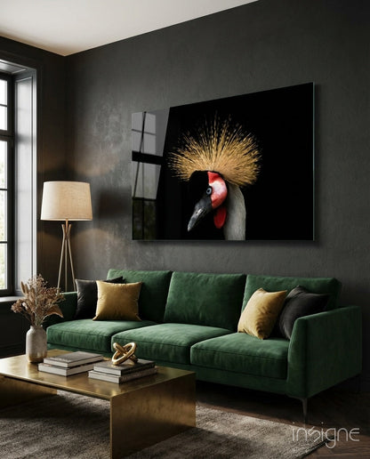 Crane Bird Glass Wall Art displaying a red-headed crane with golden crest on black background, mounted above green sofa in modern living room.