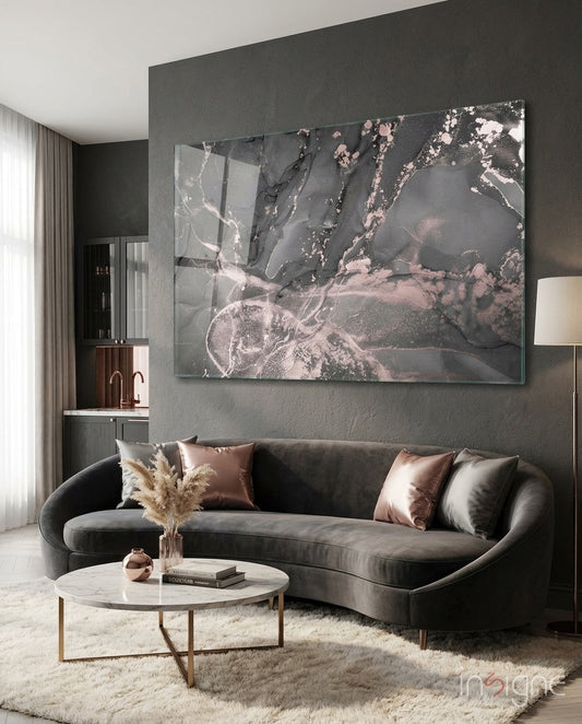 Charcoal Rose Gold Marble Glass Wall Art mounted above a curved gray sofa in a modern living room setting.