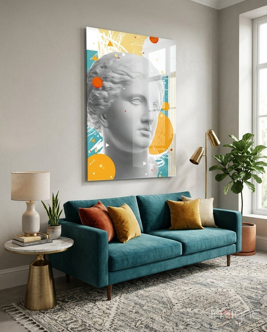 Modern living room interior featuring teal sofa with colorful pillows beneath large glass wall art displaying classical bust with orange and yellow geometric elements.