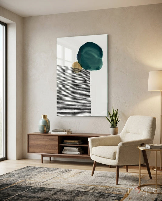 Modern living room with teal circle and black striped wall art displayed above wooden console table with cream armchair.