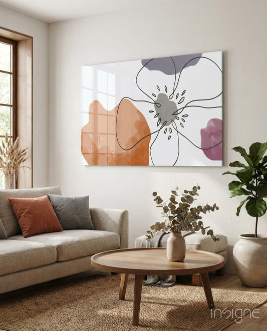 Boho line art flower glass wall art displayed above a beige sofa in a minimalist living room with warm earth tones.