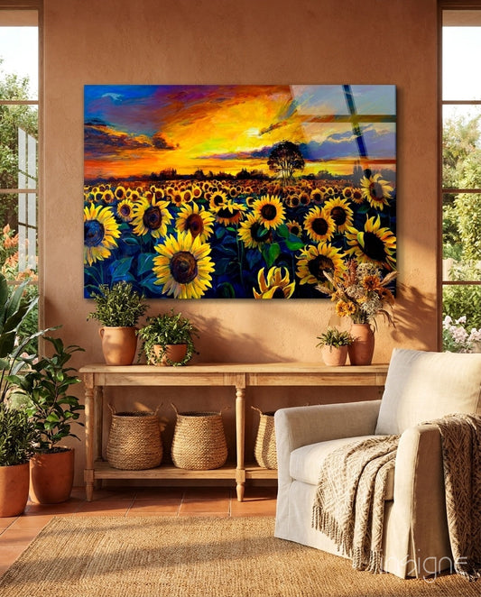 Sunflower glass wall art depicting a vibrant sunset field displayed above a wooden console table in a terracotta-walled room with potted plants and cream furniture.