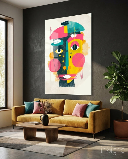 Colorful abstract cubist face artwork displayed above a mustard yellow sofa in a modern living room interior.