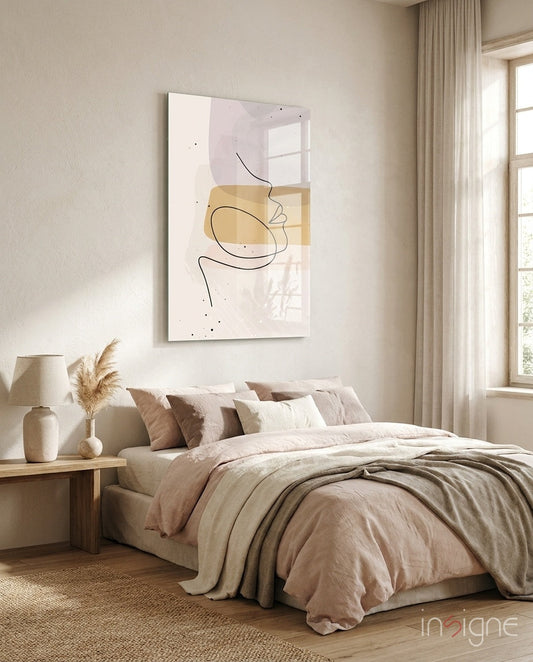 Lavender Gold Line Art Face Glass Wall Art displayed above a bed in a minimalist bedroom with neutral tones and natural light.
