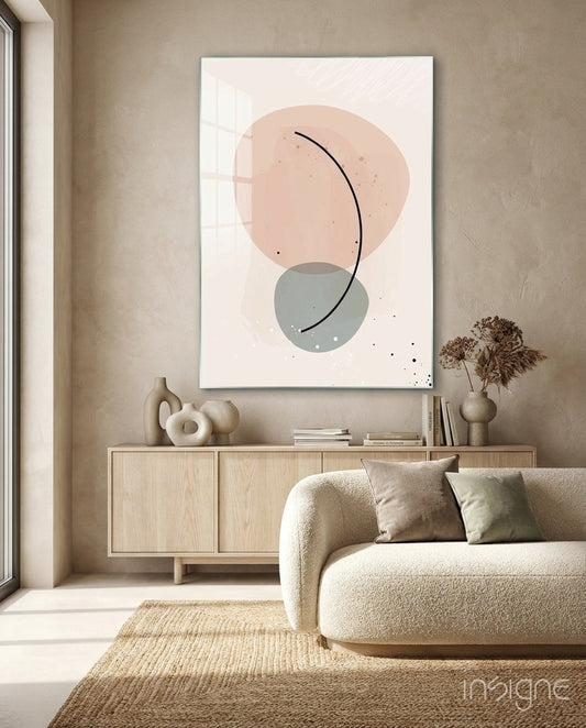 Modern minimalist living room with blush pink and sage green abstract circles and curved line wall art displayed above light wood sideboard.
