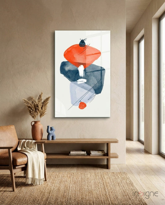 Abstract watercolor glass wall art with orange and navy shapes displayed in a minimalist living room above wooden furniture.