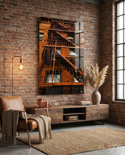 Orange Stairs Glass Wall Art displayed above wooden console table in industrial brick loft room with leather chair.