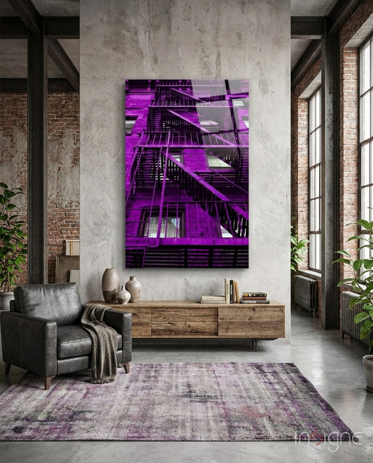 Purple neon-lit fire escape stairs glass wall art displayed in industrial loft living room with concrete walls and wooden furniture.